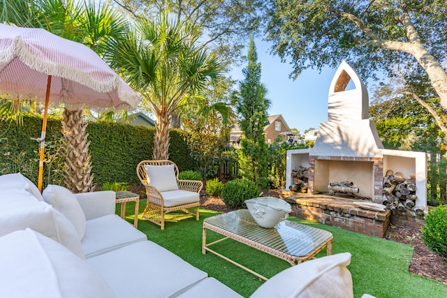 view of patio with an outdoor brick fireplace