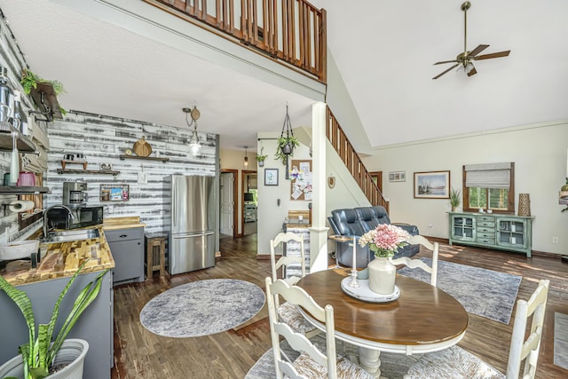 2468 Marina Rd, Wadmalaw Island, SC 29487 - dining space featuring stairway, ceiling fan, dark wood-style floors, high vaulted ceiling, and baseboards
