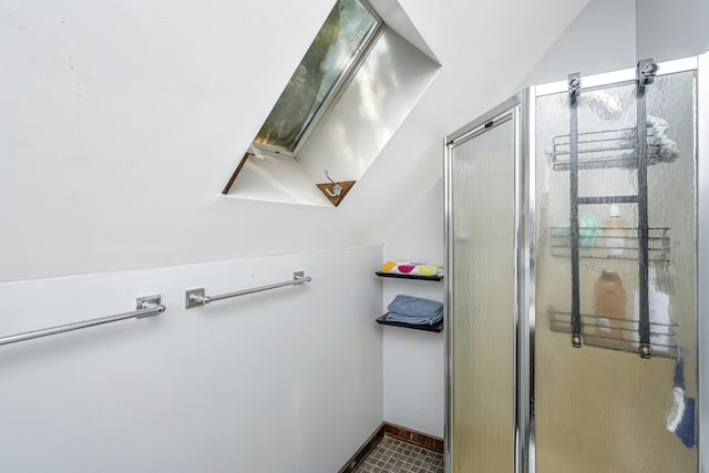 2468 Marina Rd, Wadmalaw Island, SC 29487 - bathroom featuring a shower stall, vaulted ceiling, and a skylight