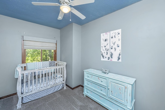 2468 Marina Rd, Wadmalaw Island, SC 29487 - carpeted bedroom featuring baseboards, a textured ceiling, a crib, and a ceiling fan