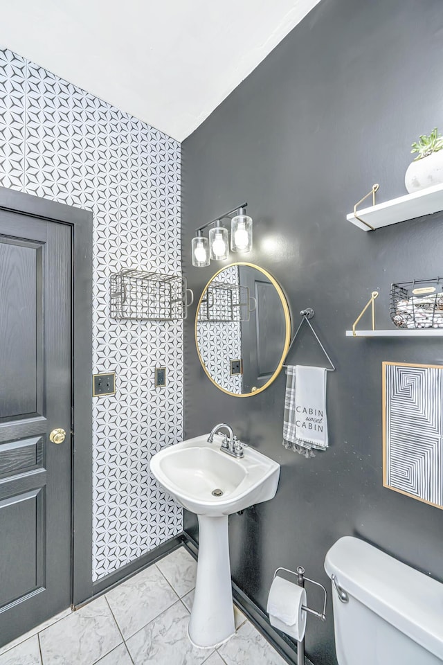 2468 Marina Rd, Wadmalaw Island, SC 29487 - bathroom featuring toilet and marble look tiles