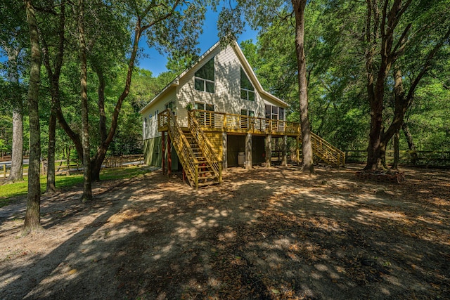 2468 Marina Rd, Wadmalaw Island, SC 29487 - back of house featuring stairway, a deck, and dirt driveway