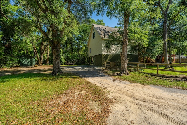 2468 Marina Rd, Wadmalaw Island, SC 29487 - view of front facade featuring driveway, a storage unit, and an outbuilding