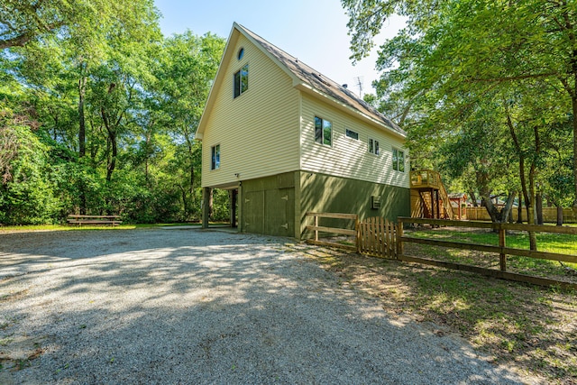 2468 Marina Rd, Wadmalaw Island, SC 29487 - view of property exterior with gravel driveway, fence, and a carport