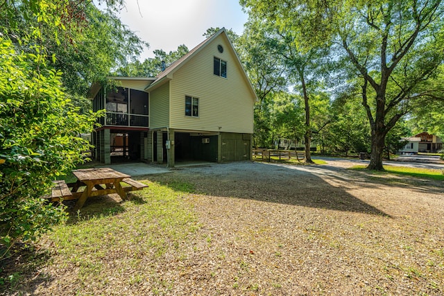 2468 Marina Rd, Wadmalaw Island, SC 29487 - view of side of property with a sunroom and gravel driveway