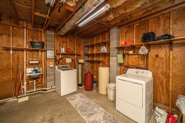 2468 Marina Rd, Wadmalaw Island, SC 29487 - unfinished below grade area featuring washing machine and dryer, a water softener, and a sink