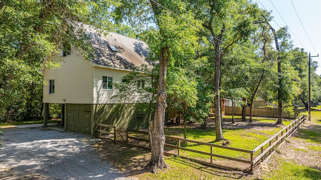 2468 Marina Rd, Wadmalaw Island, SC 29487 - view of side of property featuring fence, gravel driveway, and a shingled roof