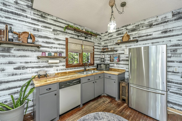 2468 Marina Rd, Wadmalaw Island, SC 29487 - kitchen featuring stainless steel appliances, open shelves, gray cabinets, wooden walls, and a textured ceiling