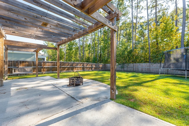 view of patio / terrace with a fire pit, a trampoline, and a pergola