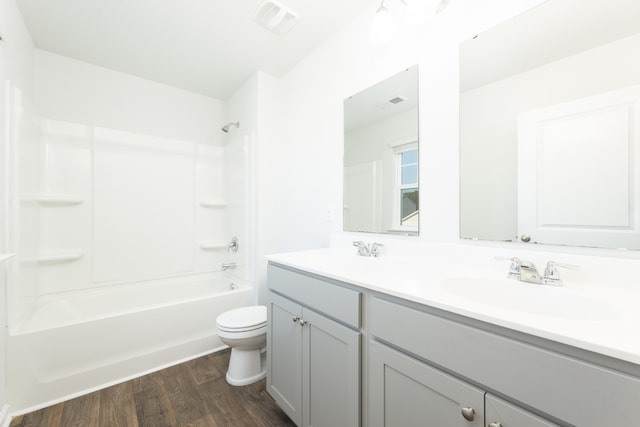 full bathroom featuring vanity, toilet, wood-type flooring, and shower / bathtub combination