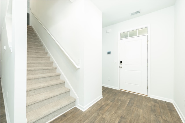 entryway with dark hardwood / wood-style floors