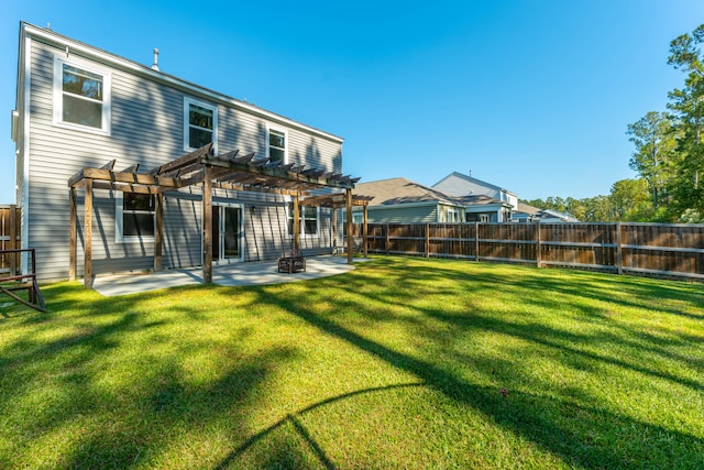 back of house featuring a yard, a patio, and a pergola