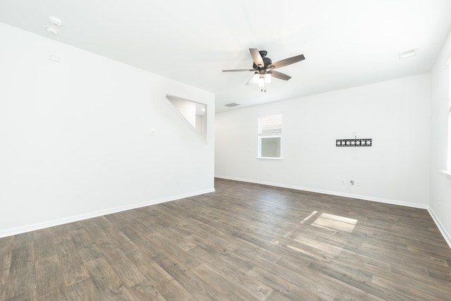 spare room with ceiling fan and dark hardwood / wood-style floors