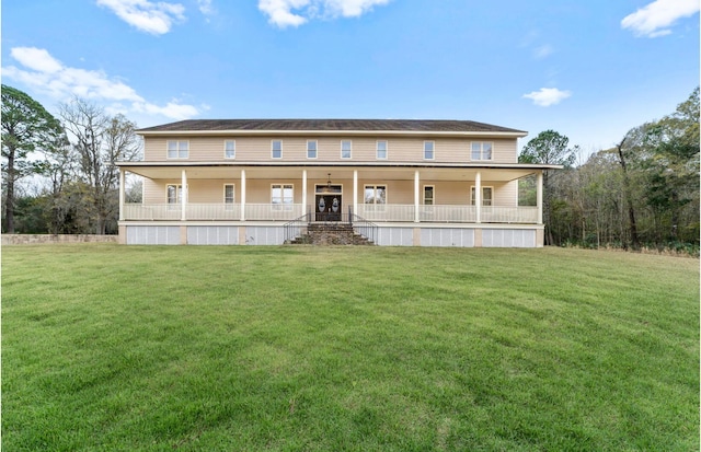 rear view of house with a yard and covered porch