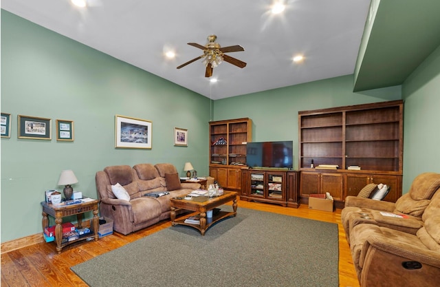 living room with ceiling fan and hardwood / wood-style floors