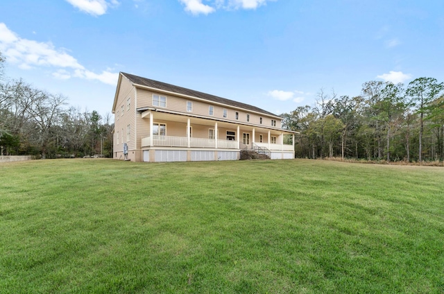 rear view of house with a yard and covered porch