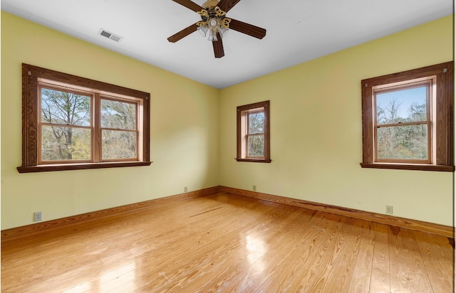 empty room featuring ceiling fan and light hardwood / wood-style flooring