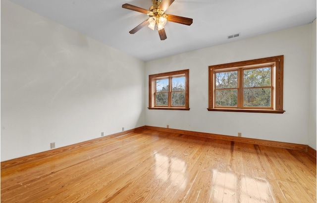 spare room with ceiling fan and light wood-type flooring