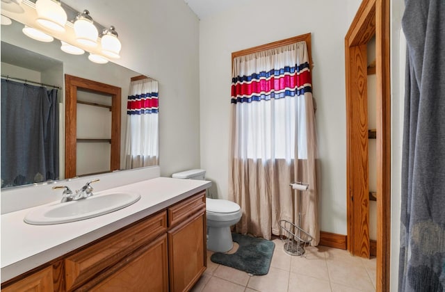 bathroom featuring vanity, toilet, and tile patterned flooring