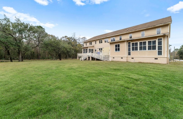 back of property featuring a yard and a deck