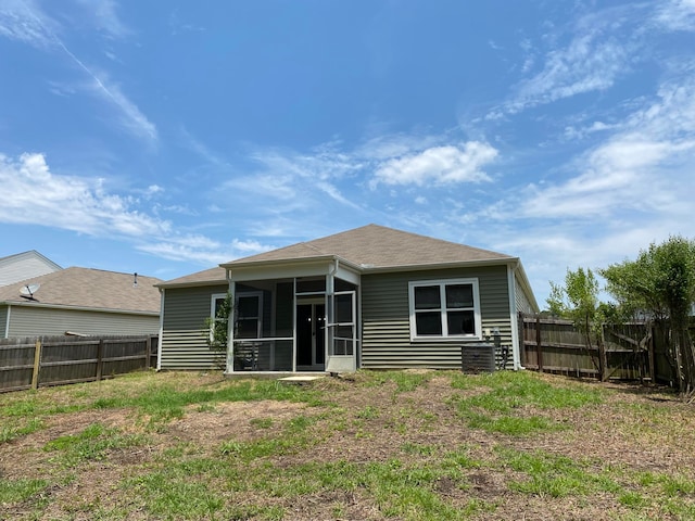 rear view of property featuring a sunroom