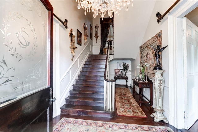 81 Rutledge Ave, Charleston, SC 29401 - stairway with a decorative wall, wood finished floors, a chandelier, and wainscoting