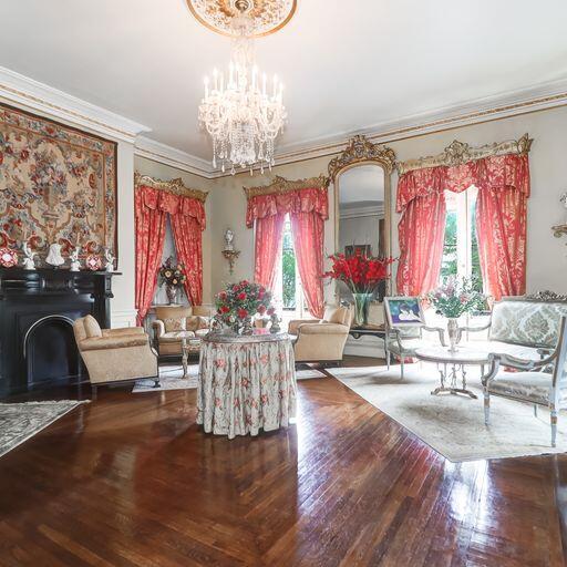 81 Rutledge Ave, Charleston, SC 29401 - living area featuring a chandelier, crown molding, wood finished floors, and a fireplace
