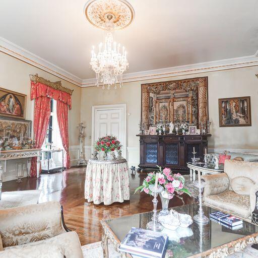 81 Rutledge Ave, Charleston, SC 29401 - living room featuring ornamental molding, a chandelier, and wainscoting