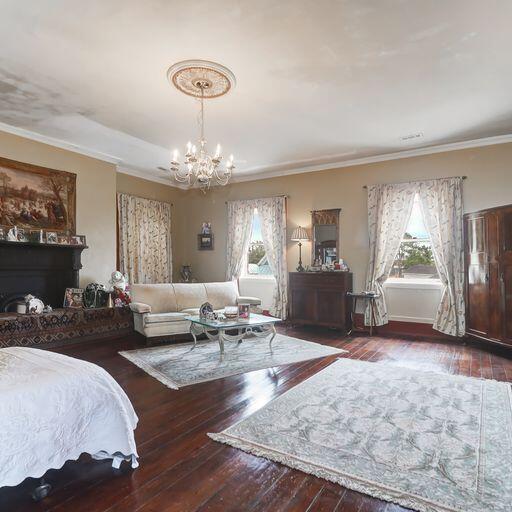 81 Rutledge Ave, Charleston, SC 29401 - bedroom featuring multiple windows, a chandelier, hardwood / wood-style flooring, and ornamental molding