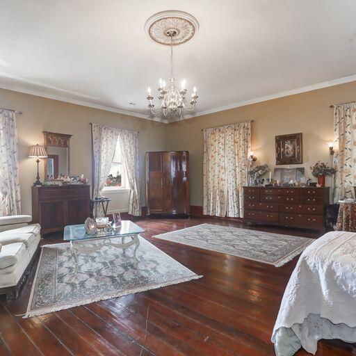 81 Rutledge Ave, Charleston, SC 29401 - bedroom featuring a chandelier, wood-type flooring, and crown molding