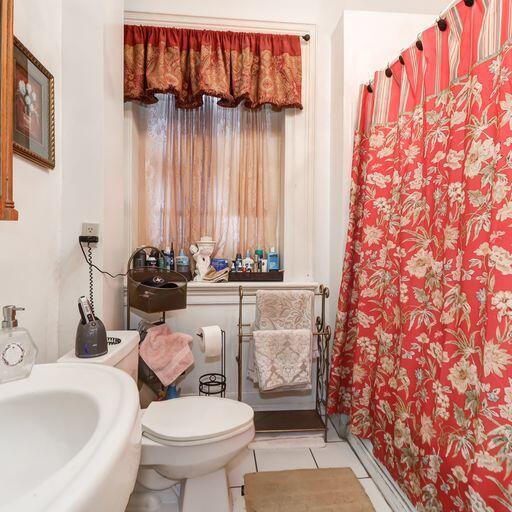 81 Rutledge Ave, Charleston, SC 29401 - bathroom with a sink, tile patterned flooring, toilet, and a shower with curtain