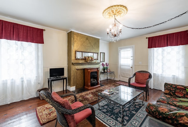 81 Rutledge Ave, Charleston, SC 29401 - living room featuring a chandelier, wood finished floors, ornamental molding, and a wainscoted wall