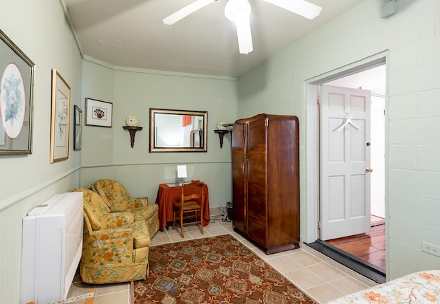 81 Rutledge Ave, Charleston, SC 29401 - sitting room featuring concrete block wall, a ceiling fan, tile patterned flooring, and wainscoting