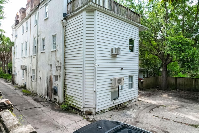 81 Rutledge Ave, Charleston, SC 29401 - view of side of home featuring a balcony, a wall mounted AC, and a cooling unit