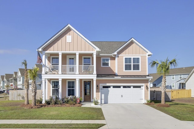 view of front of house featuring a garage, concrete driveway, a balcony, board and batten siding, and a front yard