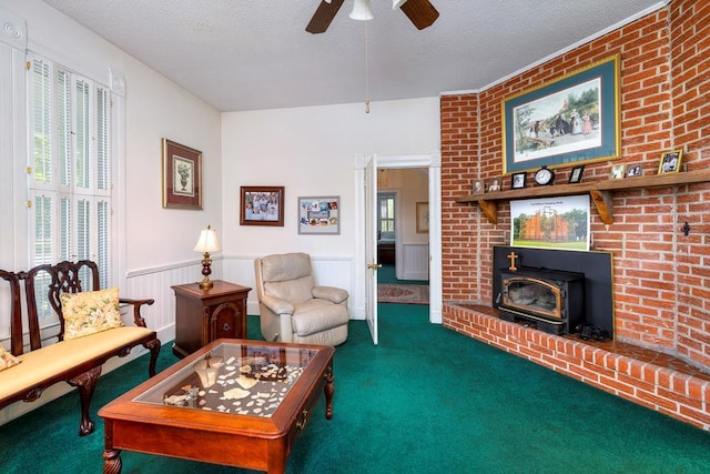 carpeted living room featuring a textured ceiling, a wood stove, and ceiling fan