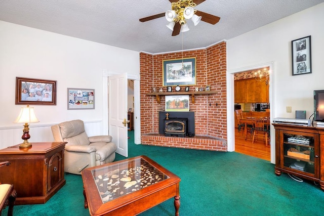 living room featuring dark colored carpet, ceiling fan, a wood stove, and a textured ceiling