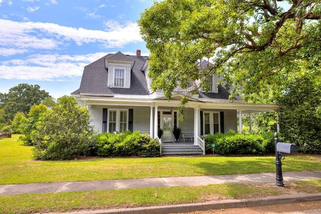 view of front of property featuring a porch and a front lawn