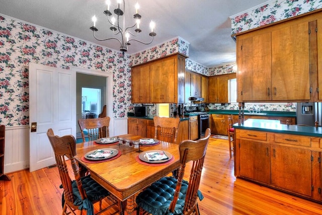 dining room with a notable chandelier and light hardwood / wood-style floors