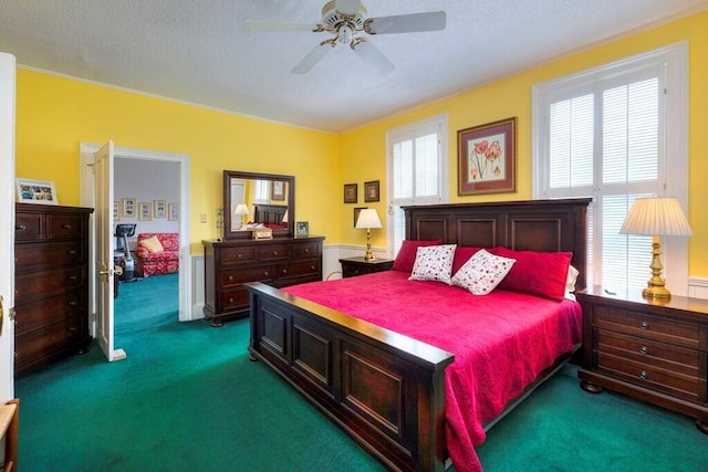 carpeted bedroom with ceiling fan and a textured ceiling