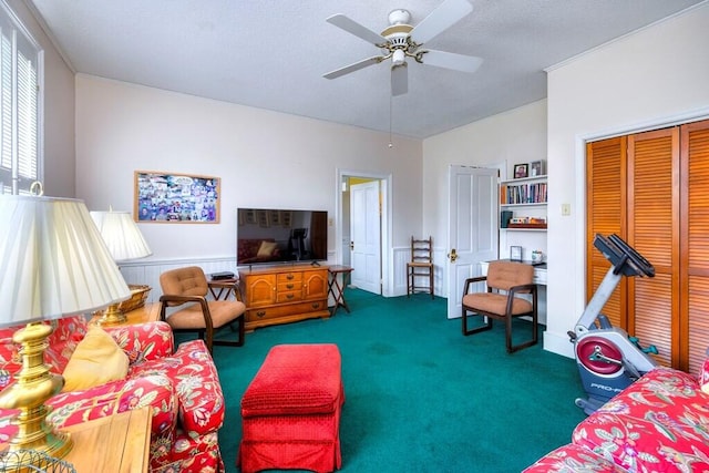 carpeted living room with ceiling fan and vaulted ceiling