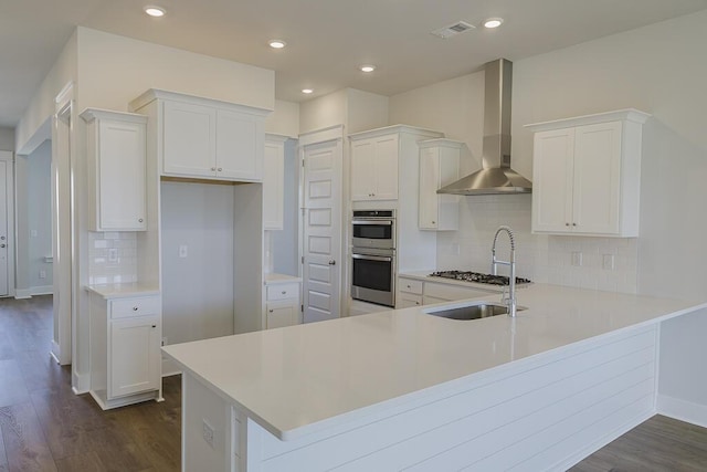 444 Parish Farms Dr, Summerville, SC 29486 - kitchen featuring wall chimney range hood, appliances with stainless steel finishes, dark wood-type flooring, tasteful backsplash, and recessed lighting