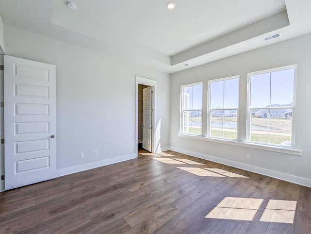 444 Parish Farms Dr, Summerville, SC 29486 - empty room featuring a raised ceiling, a smoke detector, dark wood-style floors, recessed lighting, and a water view