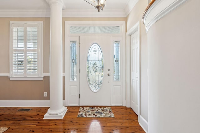 foyer entrance with visible vents, baseboards, ornamental molding, wood-type flooring, and decorative columns