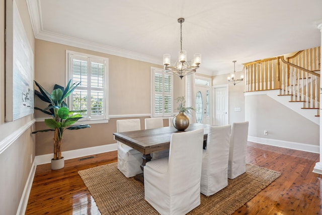 dining area featuring wood-type flooring, crown molding, stairway, and a notable chandelier