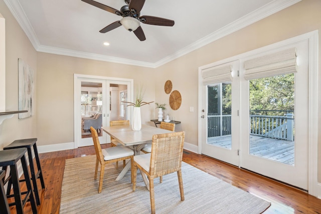 dining room with french doors, baseboards, and hardwood / wood-style flooring