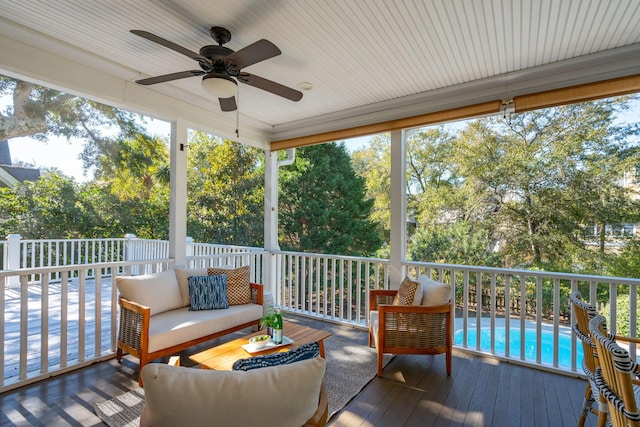 sunroom / solarium featuring a ceiling fan and a healthy amount of sunlight