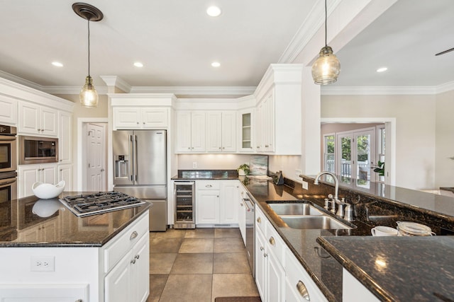 kitchen featuring wine cooler, white cabinetry, stainless steel appliances, and a sink