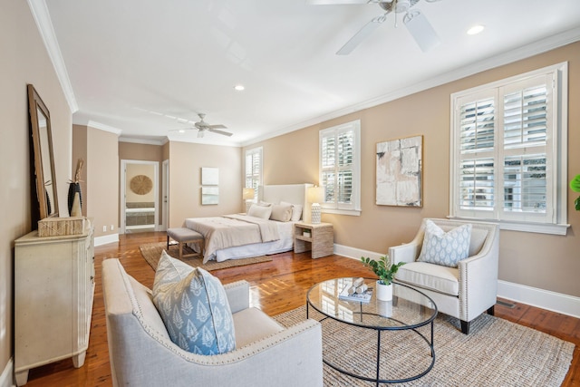 bedroom with ornamental molding, recessed lighting, wood finished floors, and baseboards