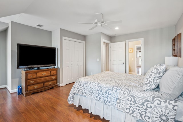 bedroom featuring a closet, visible vents, baseboards, and wood finished floors